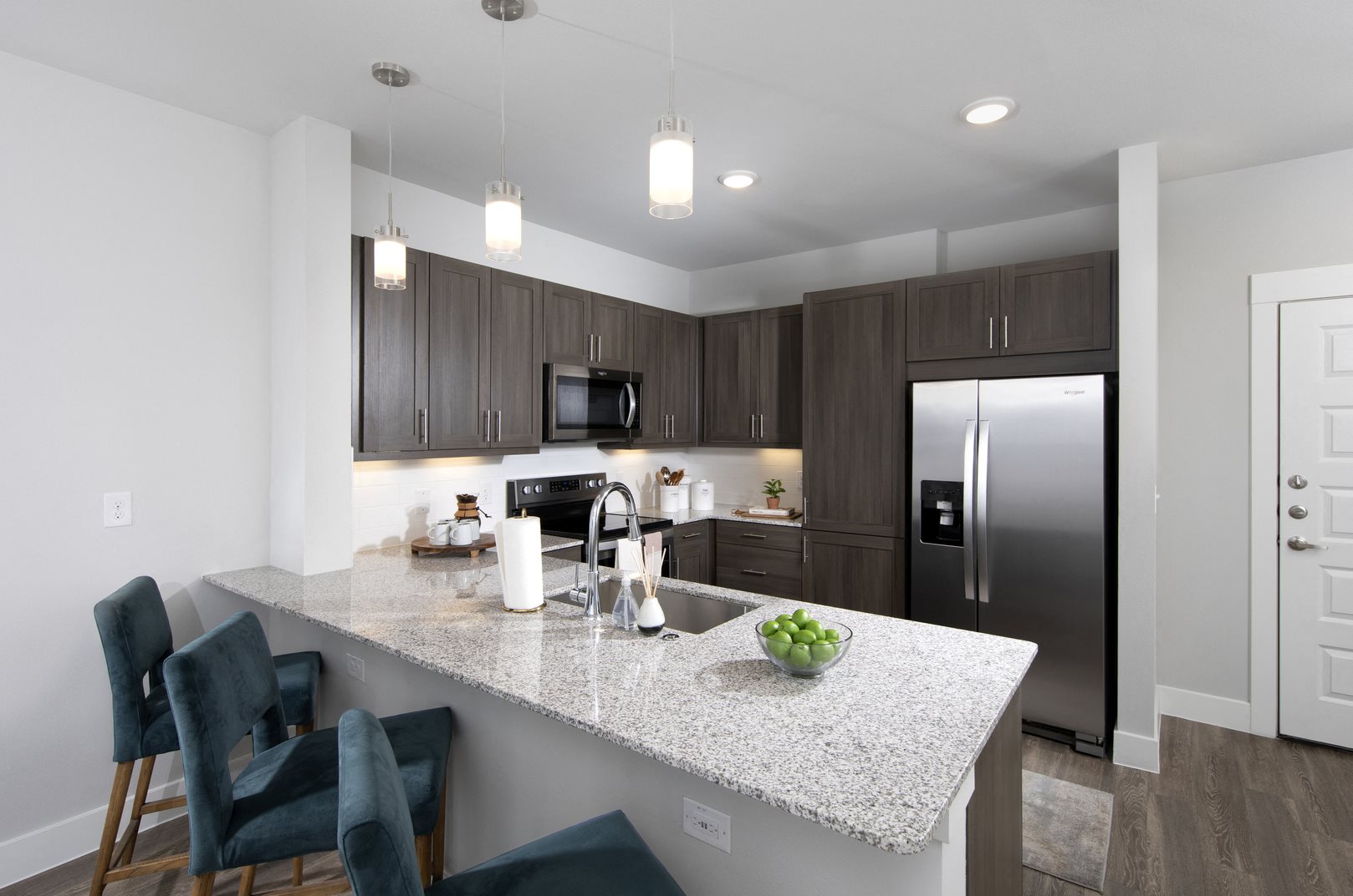 a kitchen with stainless steel applainces and granite countertops